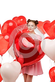 Valentine& x27;s day. Beauty girl holding red air balloons, symbols of love. Happy Young woman laughing. Model having fun