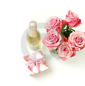 Valentine`s day, birthday background. Bouquet of pink roses flowers, gift box and champagne bottle isolated