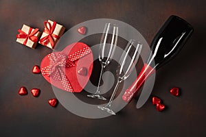 Valentine`s Day with a bottle of champagne glasses of chocolates and gifts. Top view with copy space