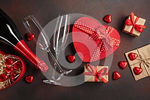 Valentine`s Day with a bottle of champagne glasses of chocolates and gifts. Top view with copy space