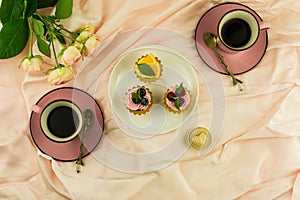 Valentine`s day.breakfast for two. two cups of freshly brewed coffee, mini torilla with cream and fruit. the concept of a romanti