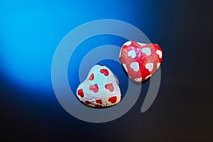 Valentine's Day candies on a blue-black background. Red candy hearts with space for text