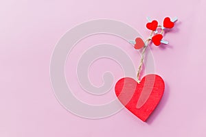 Valentine`s day card. wooden red hearts isolated on pink background.happy valentine day concept. Festive postcard. Love