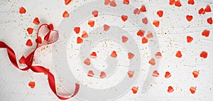 Valentine's day card. Red ribbon forming hearts and many red hearts on white background. Wedding invitation. Flat