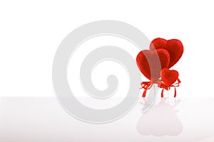 Valentine`s Day. Card, three red hearts family, isolated on a white background with reflection.