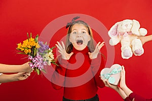 Valentine`s day celebration, happy caucasian girl isolated on red background