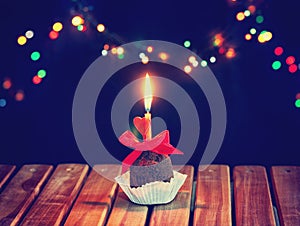 Valentine`s day chocolate cupcake with candle and heart