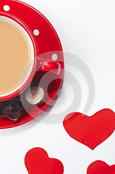 Valentine`s day composition with coffee cup and box of chocolate hearts on white background. Love and Valentine`s Day concept