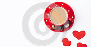 Valentine`s day composition with coffee cup and box of chocolate hearts on white background. Love and Valentine`s Day concept
