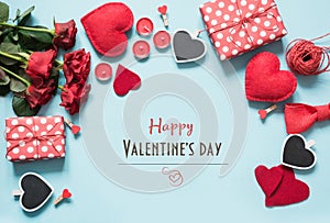 Valentine`s day composition with gifts, red hearts on blue surface. Top view