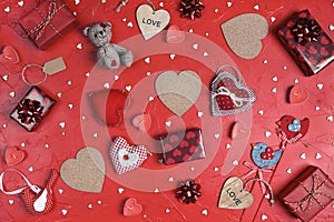 Valentine`s day composition with many different hearts and gifts on red background