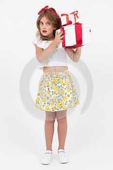 Valentine`s day concept. beautiful attractive girl holds a gift she has just received on a white background