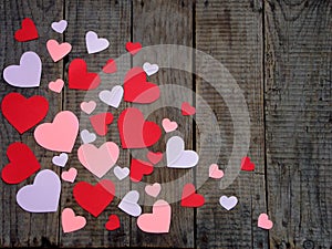 Valentine`s Day concept. Composition of paper colourful hearts on wooden background.