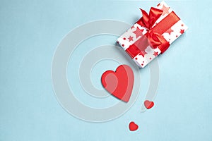 Valentine& x27;s day concept. Gift and hearts on a blue background