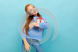 Valentine`s day concept. girl with a gift on a light blue background