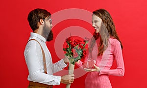 Valentine`s day concept. happy young couple with heart, flowers