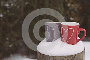 Valentine`s day concept with hearts and cups over nature