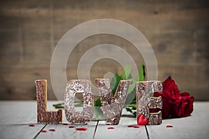 Valentine`s Day concept. Love wooden letters on wooden rustic background