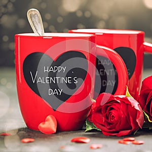 Valentine's Day concept with Red Cups and roses on a Wooden Background