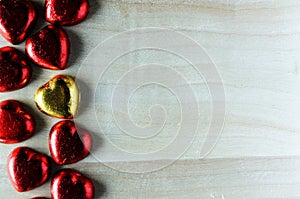 Valentine`s day concept with red gold hearts chocolate on wooden backgrounds