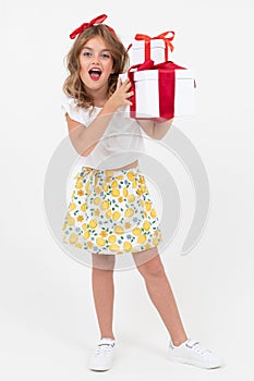 Valentine`s day concept. surprised beautiful attractive girl holds a gift she has just received on a white background