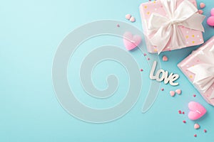 Valentine`s Day concept. Top view photo of light pink gift boxes with white ribbon bows inscription love heart shaped candles and