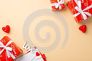 Valentine`s Day concept. Top view photo of red gift boxes envelope with letter heart shaped candles and inscription love on