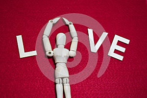 Valentine`s day concept. wooden puppet on ted color acrylic felt.