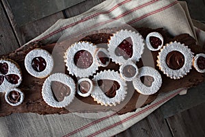 Valentine's Day cookies on wood table with napkin and metal