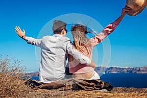 Valentine`s day. Couple in love enjoying sea landscape on honeymoon on Santorini island, Greece. Vacation and traveling