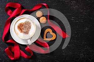 Valentine`s day. Cup of cappuccino coffee with heart on foam