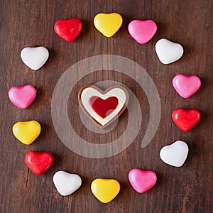 Valentine\'s Day is a cute and delicious sugar cookie with a pink heart and a sweet pattern on a wooden background. I love
