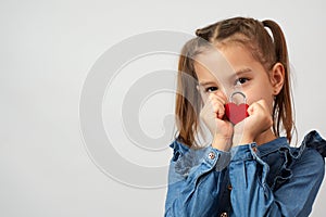 Valentine's day. Cute little child girl holding red heart