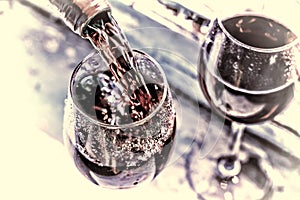 Valentine`s day, date, love, Celebration. pouring red wine. Wine in a glass, selective focus, motion blur, Red wine in a glass. S