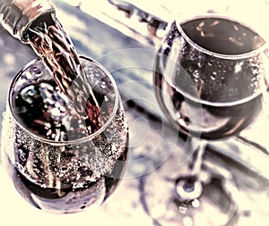 Valentine`s day, date, love, Celebration. pouring red wine. Wine in a glass, selective focus, motion blur, Red wine in a glass. S