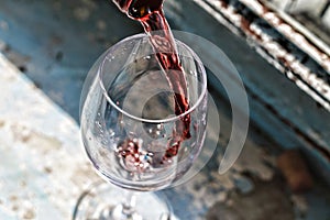 Valentine`s day, date, love, Celebration. pouring red wine. Wine in a glass, selective focus, motion blur, Red wine in a glass. S