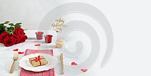 Valentine`s day dinner banner. Festive table served for romantic dinner, plate with a gift box, candles and red roses. Valentine
