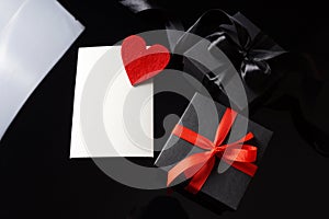 Valentine`s Day elegant background with copy space. Two gift boxes and empty greeting card with red heart symbol