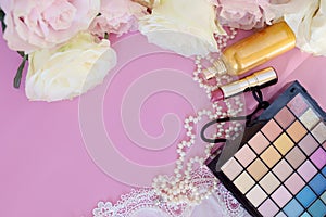 Valentine`s Day. Female accessories, jewelry, perfume bottle, gift with ribbon , pearls, gentle roses on a pink background.