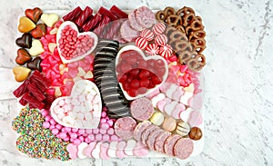 Valentine`s Day flat lay overhead candy and cookies grazing platter.