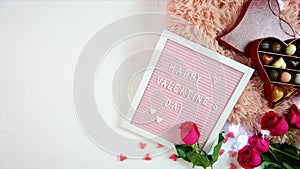 Valentine`s Day flat lay with roses, chocolates and letterboard, stop motion