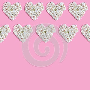 Valentine`s day floral concept. a beautiful frame of white hearts on a pink background. space for text