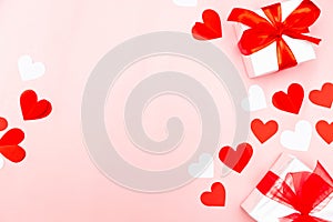 Valentine's Day. Gifts, hearts on rose background. Concept of love and affection. Holiday card.