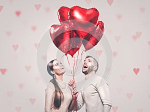 Valentine`s Day. Happy joyful couple. Portrait of smiling beauty girl and her handsome boyfriend