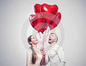 Valentine`s Day. Happy joyful couple. Portrait of smiling beauty girl and her handsome boyfriend