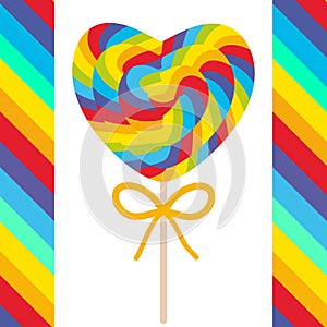 Valentine`s Day Heart shaped candy lollipops with bow, colorful spiral candy cane with bright rainbow stripes. on stick with twist