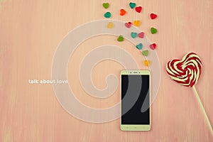 Valentine`s Day, heart shaped lollipops and phone, space for text