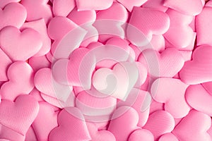 Valentine`s Day. Holiday abstract pink Valentine background with satin hearts. Love photo