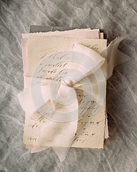 Valentine`s day inspiration, romantic vows idea, love letters. Handwritten congratulations with tender ribbon.