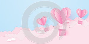 Valentine's day, love concept background, paper pink heart shaped hot air balloons floating in the sky with cloud